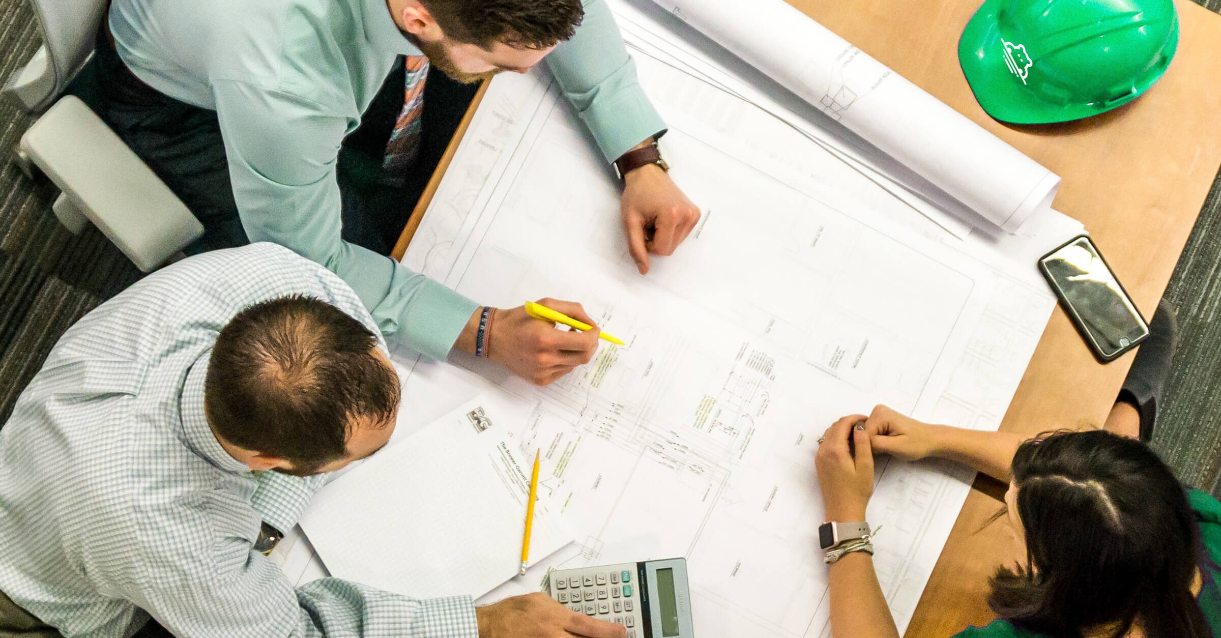 contractors looking at plans for a home improvement project