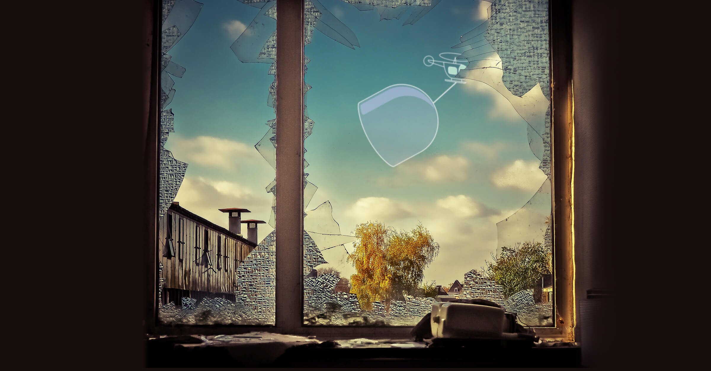 window with broken glass and an illustration of a helicopter with a glass cover in the background
