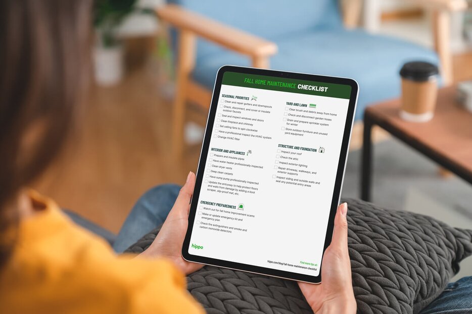 Person holding iPad and reviewing their digital fall home maintenance checklist.
