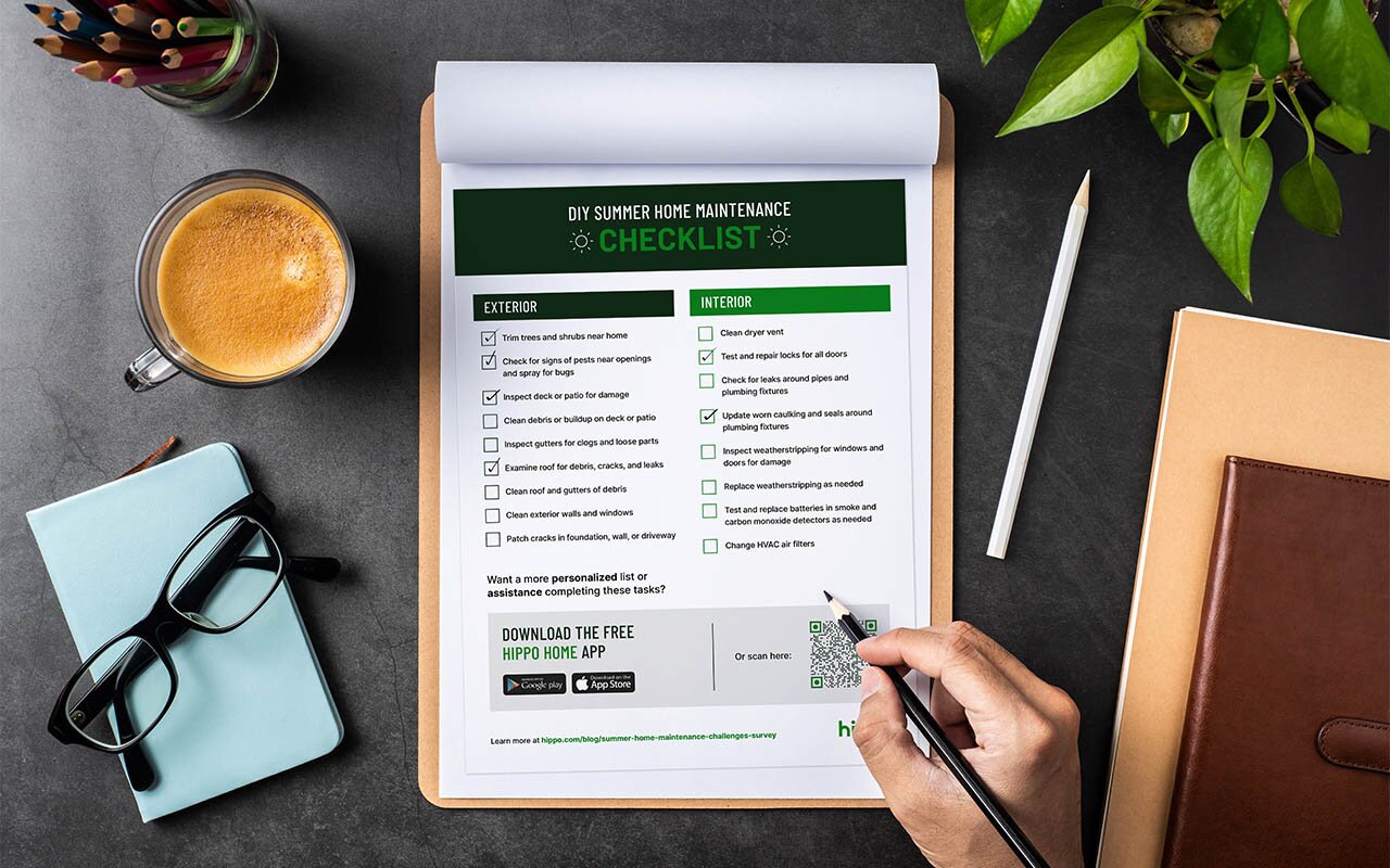 homeowner writing on their checklist of summer home maintenance tasks