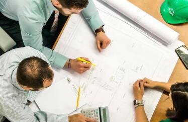 contractors looking at plans for a home improvement project